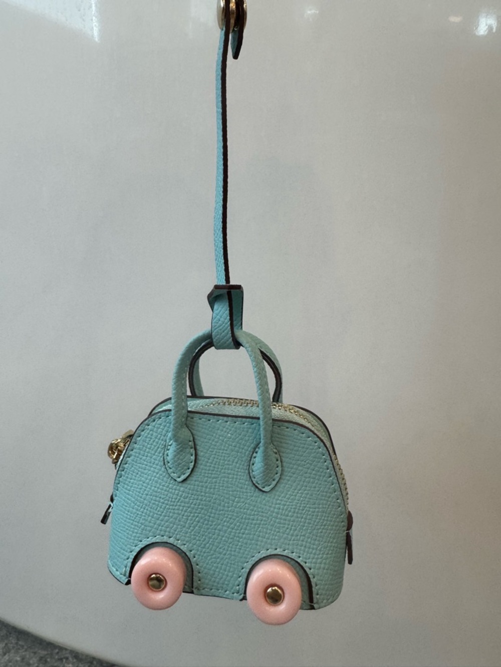 Bag charm purse on wheels bolide style light blue pink AirPod case New